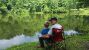 A picture of a young boy fishing with his grandfather