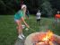 A picture of a girl toasting her s'more by the firepit